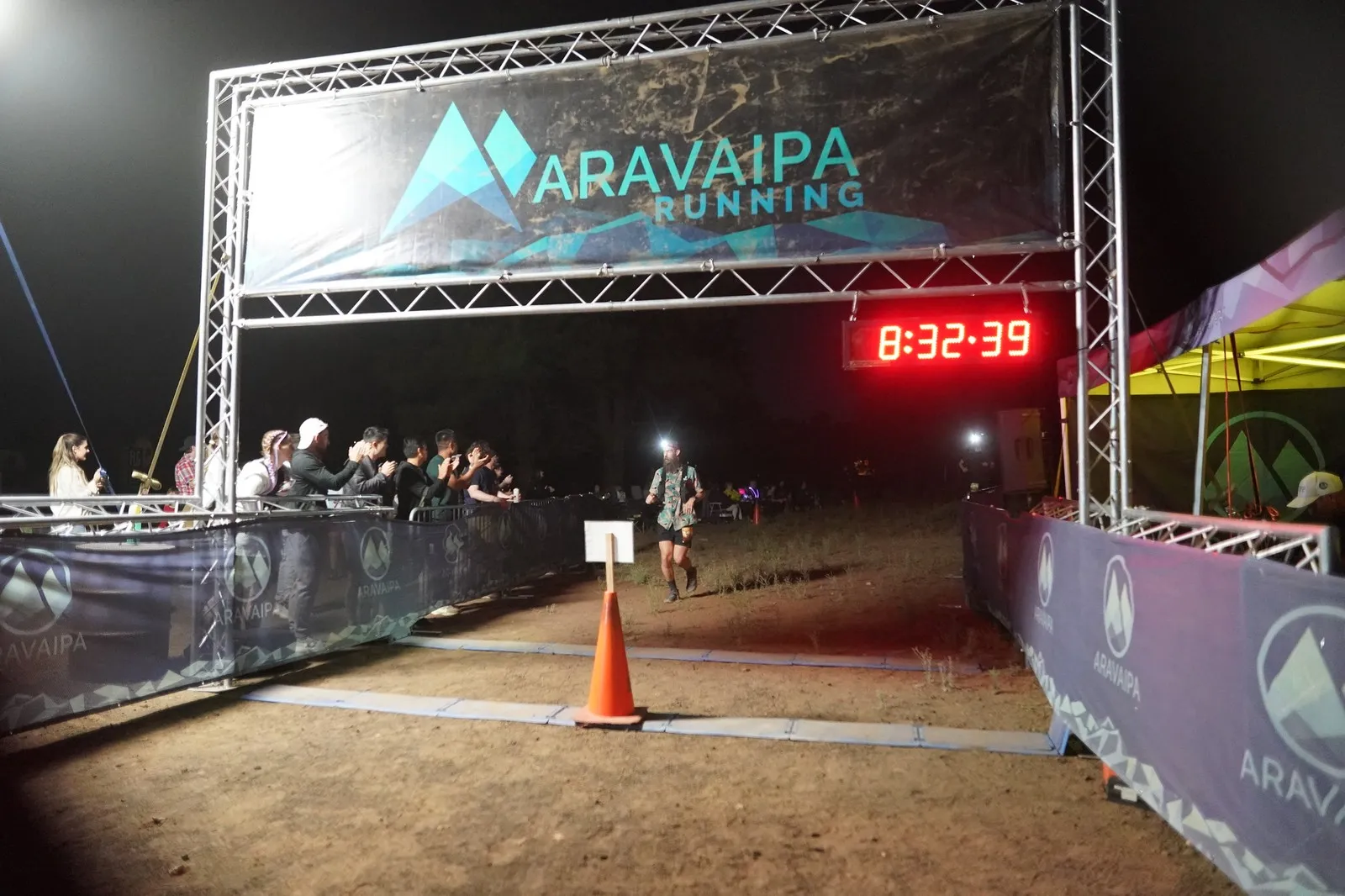 A headlamp coming in to the Blackout Night Runs finish line in the Flagstaff pines