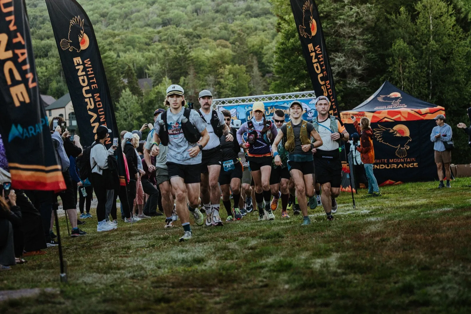 The field surges off the start line under the White Mountain Endurance flags