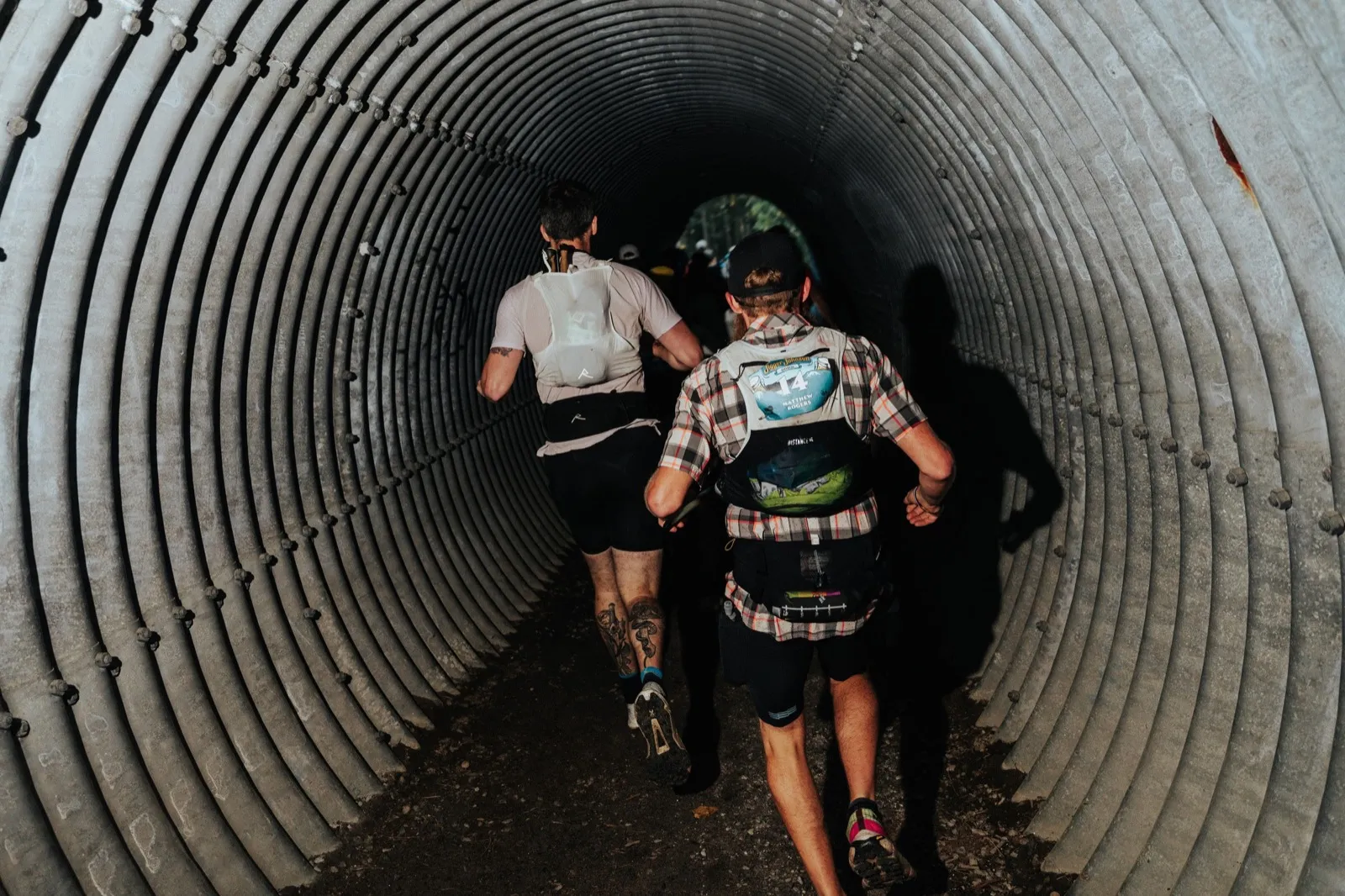 Runners file through the culvert tunnel in the first miles
