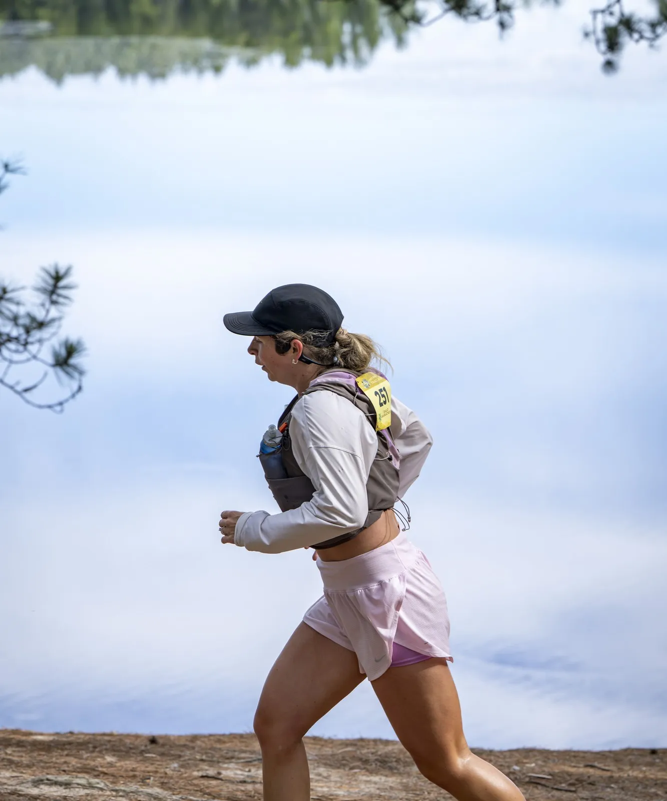 A runner along the lake shore at Two Hearted Trail Run